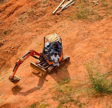 compact excavator preparing acreage for clearing